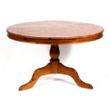A modern circular pine kitchen table on turned column and tripod base,122cms (48ins) diameter.