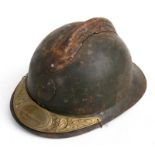 A French Adrian helmet with Soldat De La Grande Guerre 1914-1918 brass plaque attached to the visor