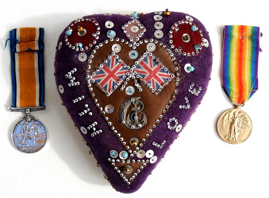 A WW1 Royal Navy sweetheart pin cushion with a WW1 medal pair named to S.S.118007 Stoker E. Upchurch