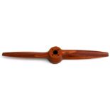 A teak aeroplane propeller, probably from a model aircraft, 78cms (30.75ins) wide.