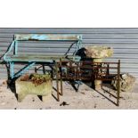A wrought iron two-seater garden bench; a stoneware planter; a stoneware two-part bird bath; and