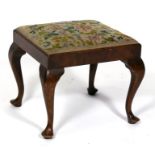 A Georgian style walnut stool with needlepoint drop-in seat, on cabriole legs.
