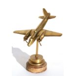 A brass model of the WW2 light bomber the Bristol Blenheim standing on its brass and wood base.