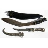 A Gurkha kukri and scabbard, 54cms (21.25ins) long; together with an Eastern dagger, sheathed, 39cms