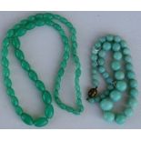 A string of graduated oval jade like beads; together with a graduated spherical jade like bead