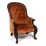 A Victorian walnut button back armchair.