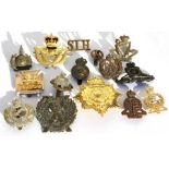 An assortment of 15 military cap badges etc