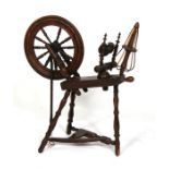 A 19th century walnut spinning wheel.