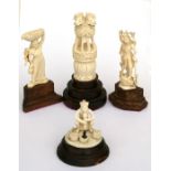 A group of early 20th century Indian ivory carvings including deities and a snake charmer (4).