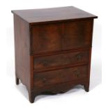 An early 19th century mahogany converted commode chest, the pair of cupboard doors above two long