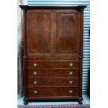 A Regency figured mahogany linen press, the moulded stepped cornice above a pair of panelled doors
