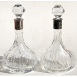 A pair of silver mounted decanters presented to 'Lieutenant Colonel J N Browell', 23cms (9ins)