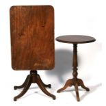 A 19th century mahogany tilt-top table, the rectangular top on turned column and quatrefoil base;