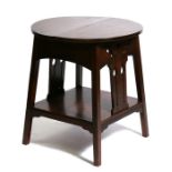 An Arts & Crafts two-tier occasional table, 58.5cms (23ins) diameter.