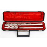 A cased silver plated flute; together with a rosewood piccolo (2). Ests?