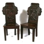 A pair of Victorian carved oak hall chairs decorated with grapes & vines.