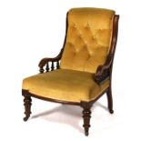 A Victorian walnut chair with upholstered seat and back standing on turned front supports.