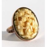 A 9ct rose gold ring set with a carved Chinese ivory panel depicting figures under a tree, approx UK