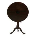 A Georgian mahogany tilt-top table on turned column and tripod base, 70cms (27.5ins) wide.