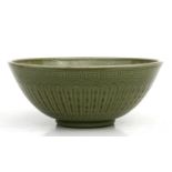 A Chinese celadon glazed bowl decorated with foliate scrolls, 29cms (11.5ins) diameter.
