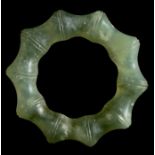 A jade / nephrite fluted pendant, 5cms (2ins) diameter.