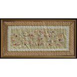 A Chinese silk embroidered panel depicting 100 boys, framed & glazed, 57 by 24cms (22.5 by 9.5ins).