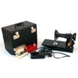 A Singer Featherweight portable sewing machine, model 221K 'CAK6-12, cased with accessories.