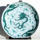 A Chinese famille verte charger decorated with dragons chasing a flaming pearl, six character blue