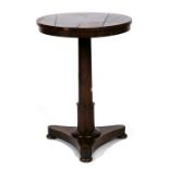 An early Victorian rosewood occasional table, the circular top on turned column and trefoil base,
