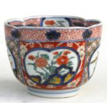 A 19th century Japanese Imari cup decorated with flowers within panels, four character blue mark