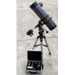 A Celestron Astro Master 130 telescope on stand with case of extra lenses.