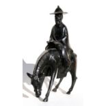 A Chinese bronze group depicting a bearded scholar on horseback reading a scroll, 36cms (14.25ins)