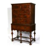 An 18th century walnut chest on stand, the top with two short & three long graduated drawers, the