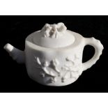A Chinese carved white soapstone teapot decorated in relief with flowers, 11cms (4.75ins) high.