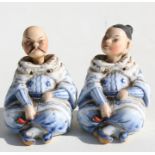 A pair of Victorian porcelain nodding figures in the form of a seated Chinese couple, 7cms (2.75ins)