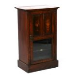 An Edwardian figured walnut music cabinet, 54cms (21.25ins) wide.