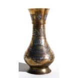 An Islamic damascene vase inlaid with silver and decorated with Islamic script, 25cms (9.75ins)