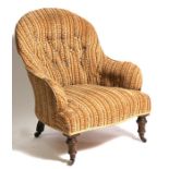 A Victorian button backed upholstered chair on turned front supports.