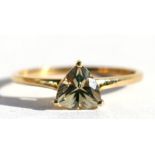 A 9ct gold dress ring set with a triangular cut pale yellow stone, approx UK size 'R'.