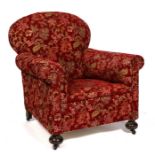 An Edwardian armchair on turned front supports.