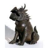 A Chinese bronze censer in the form of a seated lion, 23cms (9ins) high.