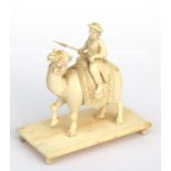 A late 19th / early 20th century Indian ivory carving depicting a figure riding a camel, 9.5cms (3.