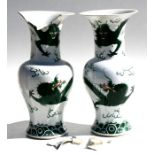 A pair of 19th century Chinese famille verte vases decorated with dragons chasing a flaming pearl,