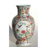 A Chinese millefiori vase decorated with birds and flowers within panels, red seal mark to