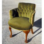 A green upholstered button back tub chair on cabriole front supports with ball & claw feet.