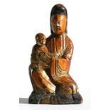 An 18th / 19th century Chinese carved gilt wood group depicting a robed woman holding a child,