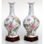 A pair of Chinese Republic style vases on stands, decorated with flowers, 27cm (10.5ins) high.