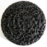 A Chinese tortoiseshell circular snuff box, profusely carved with figures on a terrace within a