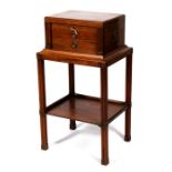 A cutlery chest on stand, the lift-up top enclosing a sectioned interior with two drawers beneath,