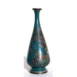 A Japanese silver wire cloisonne vase decorated with flowers on a green ground, 18cms (7ins) high.